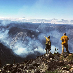 Two firefighters overlook the Miriam Fire near White Pass, Washington on August 3, 2018. Photo USDA Forest Service / Justin Gelb